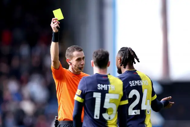 David Coote issues a yellow card during Bournemouth game.
