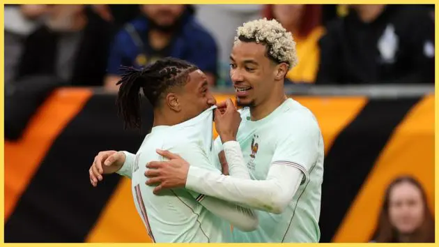 Michael Olise hugs Hugo Ekitike during France game.