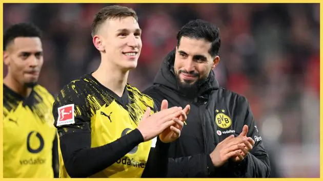 Nico Schlotterbeck and Emre Can clap their hands during Dortmund game.