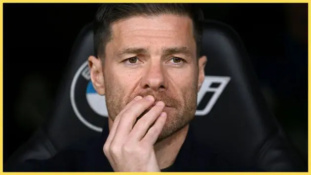 Xabi Alonso covers his mouth with his hand during Real Madrid game.