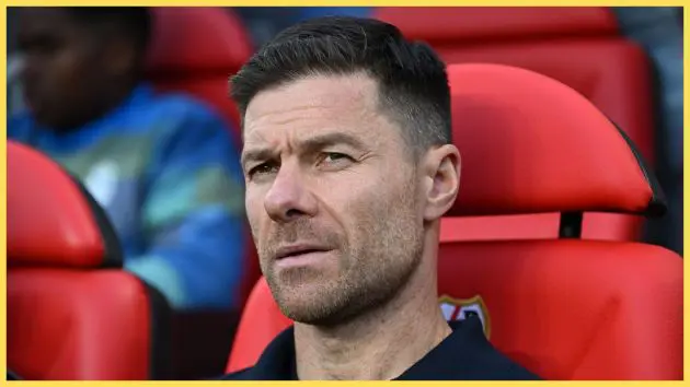 Xabi Alonso sits on the bench during Real Madrid game.