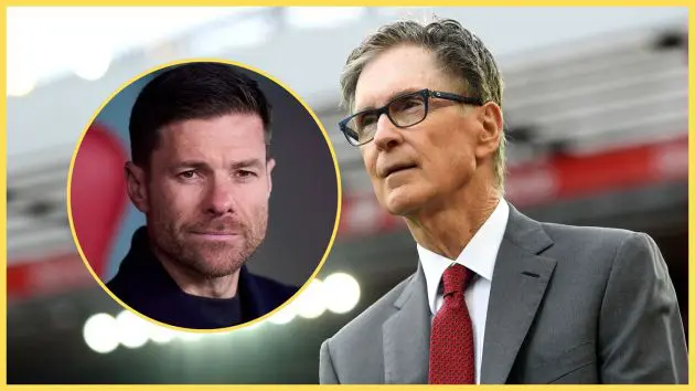Xabi Alonso smiles next to principle Liverpool owner John W Henry.