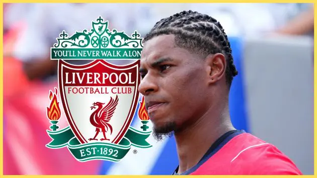 Marcus Rashford looks on next to Liverpool club crest during England practice.
