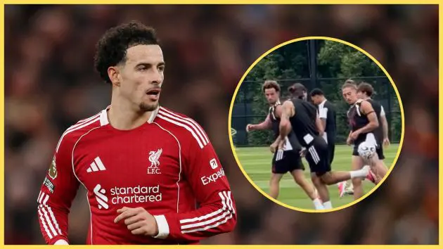 Liverpool midfielder Curtis Jones looks at a picture of him in training with Dominik Szoboszlai and Kostas Tsimikas.