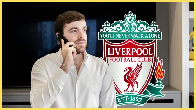 Transfer news expert Fabrizio Romano makes a phone call next to Liverpool club crest.