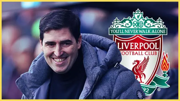 Liverpool manager Andoni Iraola smiles in front of the club badge.