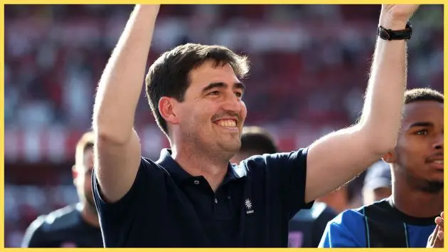 Liverpool manager Andoni Iraola celebrates with his arms in the air.