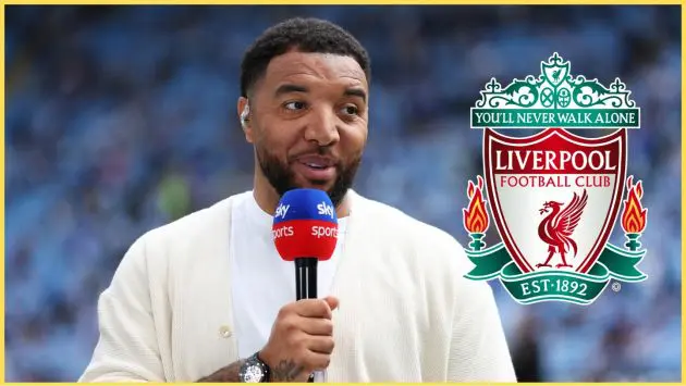 Troy Deeney pictured beside the Liverpool crest