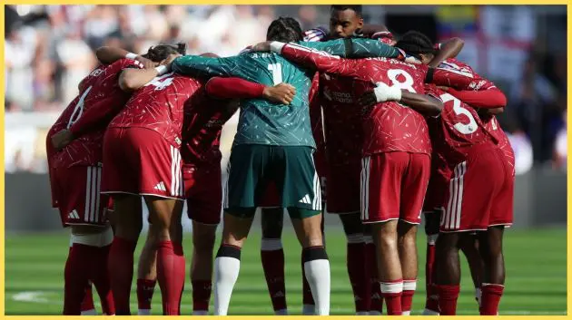 Liverpool players form a huddle prior to kick-off